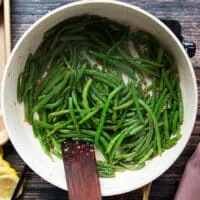 Uncovered skillet with the green beans cooked perfectly over medium low heat for a few minutes until tender