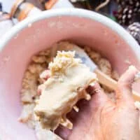 A hand holding the sugar cookie dough when finished to show the texture of the soft dough, not sticky and not dry, but rather soft