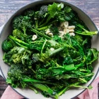 Broccoli Rabe and garlic slices in a deep oval skillet with butter or olive oil, sautéed