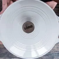 A lid covering the skillet to cook the rapini fully