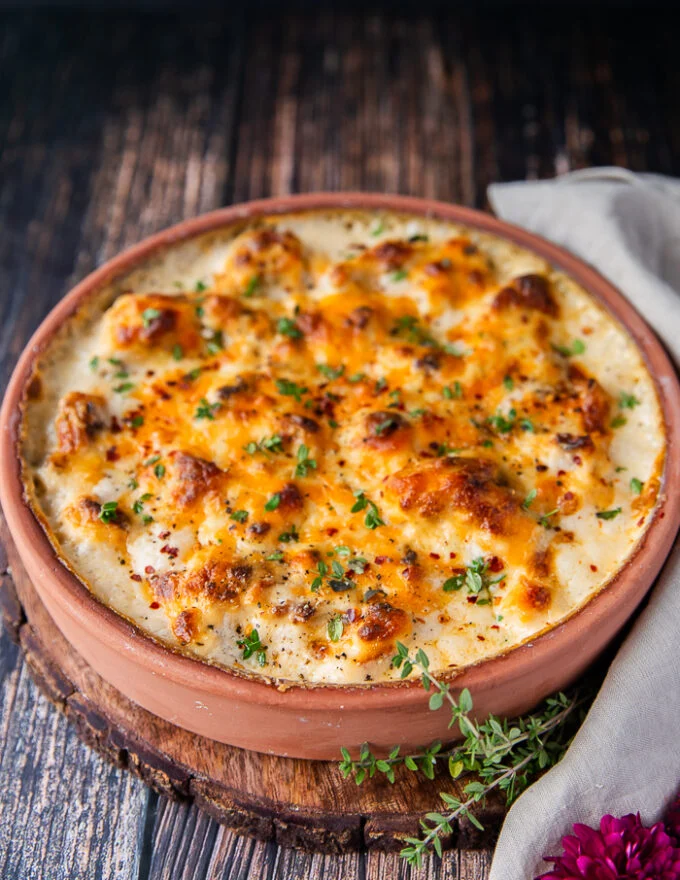 side view of the cauliflower casserole out of the oven with golden tops