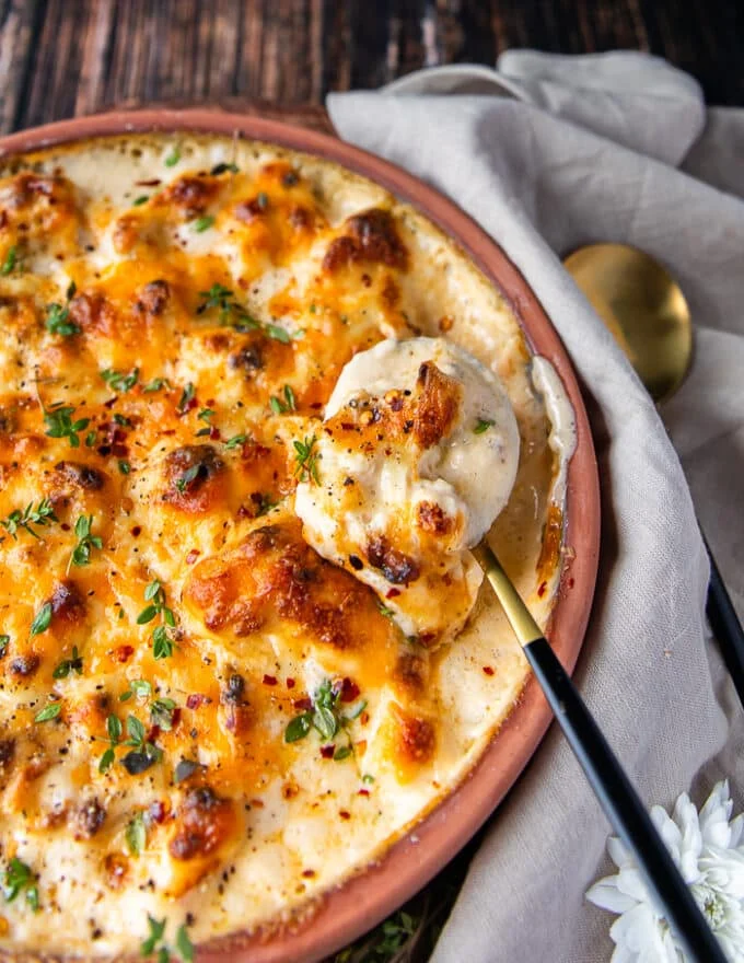Perfect spoon of cauliflower casserole showing close up the cauliflower and the sauce around it