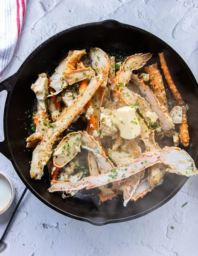 The crab is cooked on a cast iron skillet with some butter, garlic and seasoning