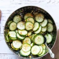 The easy cucumber salad is now tossed with the dressing a bowl
