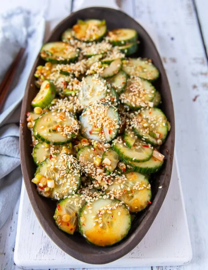 A side view plate of easy cucumber salad dressed up and sprinkled with sesame seeds