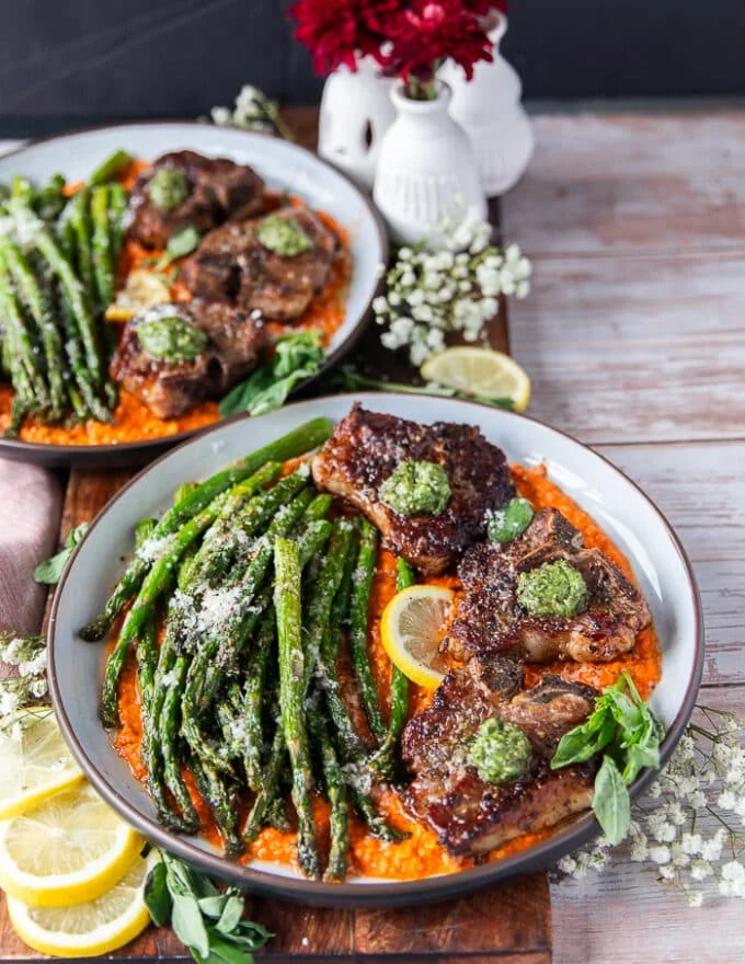 side view of a plated lamb chops dinner showing the thickness of the cooked lamb chops