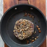The ahi tuna seared on high heat in a skillet
