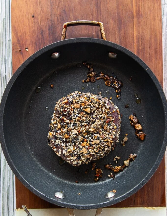 The ahi tuna seared on high heat in a skillet