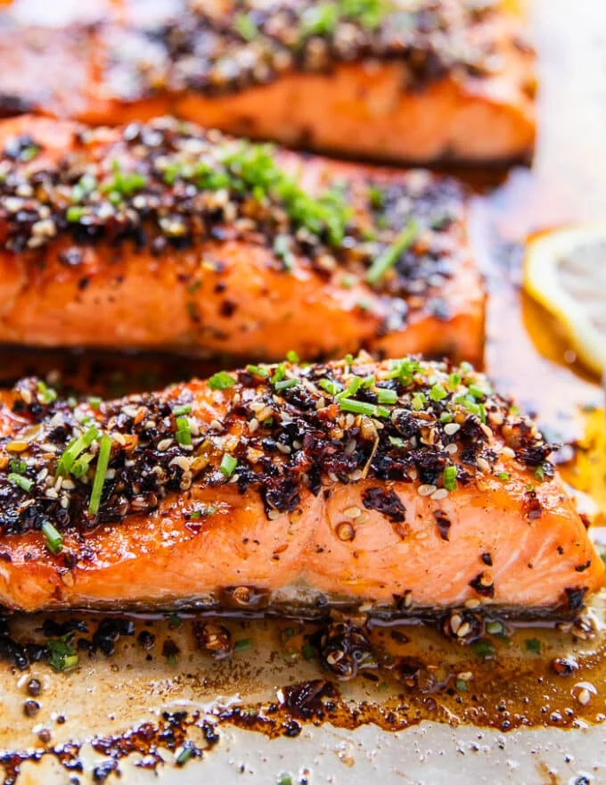 close up of a sweet chili salmon showing the texture of the chili oil crust and the succulent thick fillets of salmon
