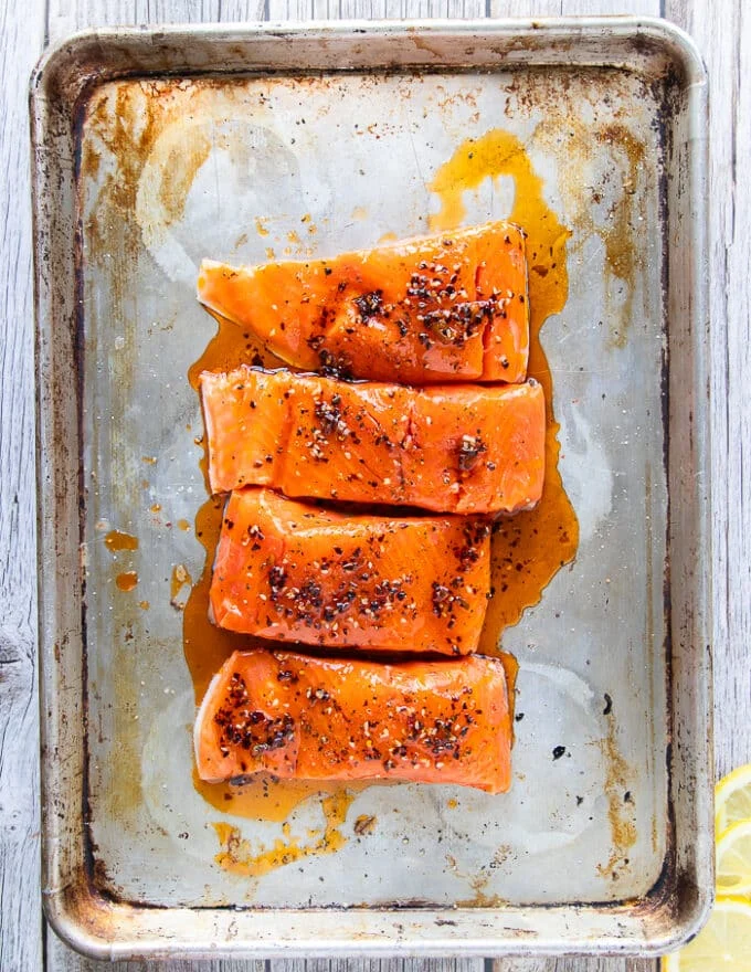 marinated salmon fillets on both sides with the chili sauce ready to bake or broil