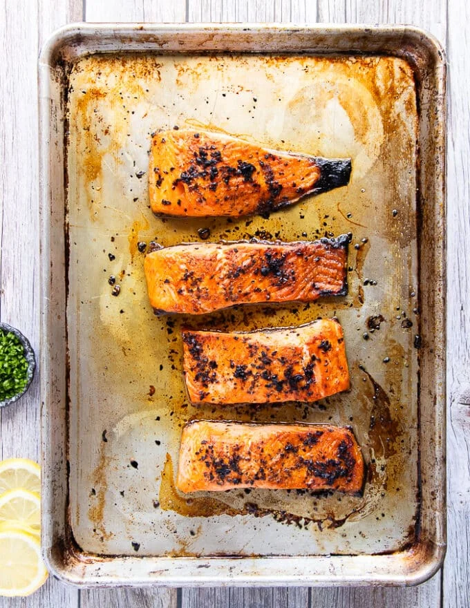 Broiled salmon with the sweet chili sauce on the baking sheet, cooked and ready