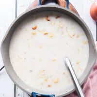 The coconut milk is added to the pot of rice