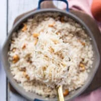 A spoon showing close up of the cooked fluffy coconut rice