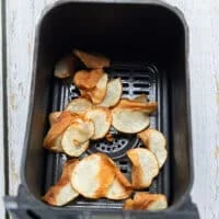 golden air fried potatoes in a basket of the air fryer