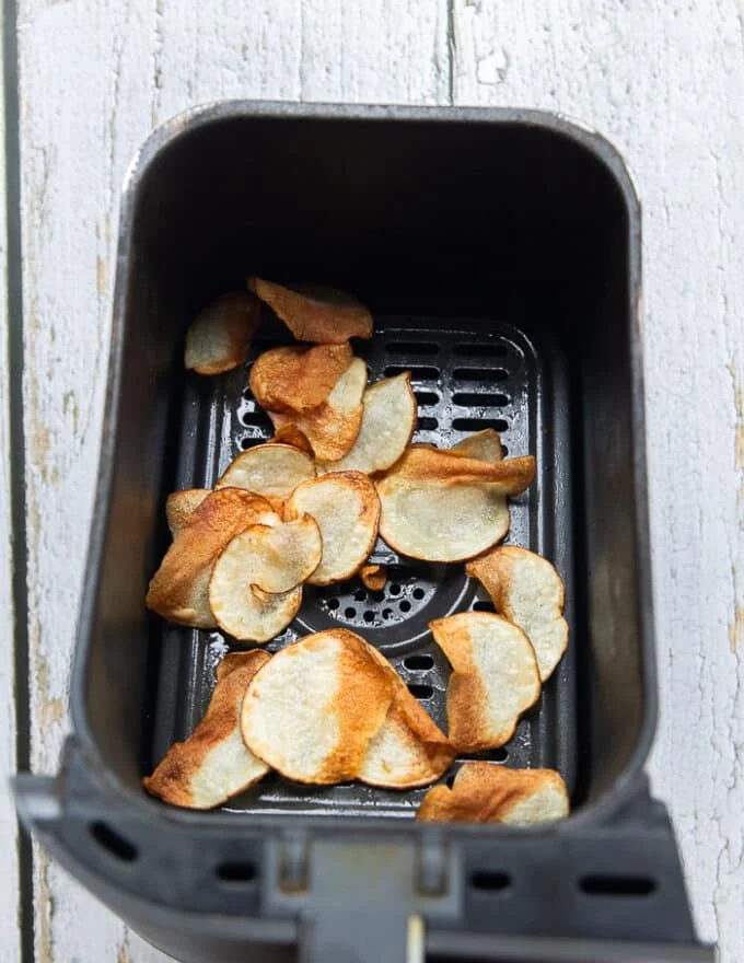 golden air fried potatoes in a basket of the air fryer