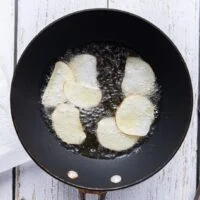 a few potato slices frying in very hot oil
