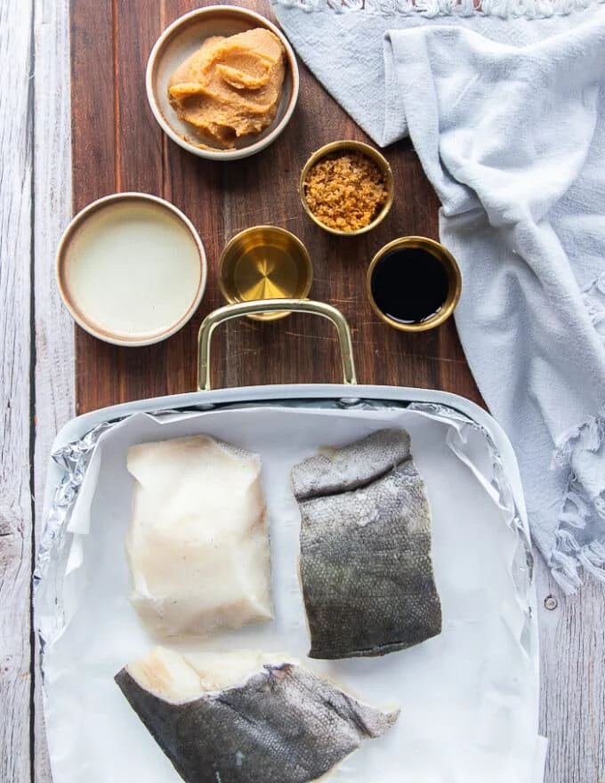 ingredients to make miso cod recipe including black cod, miso paste, mirin, sake, brown sugar and soy sauce
