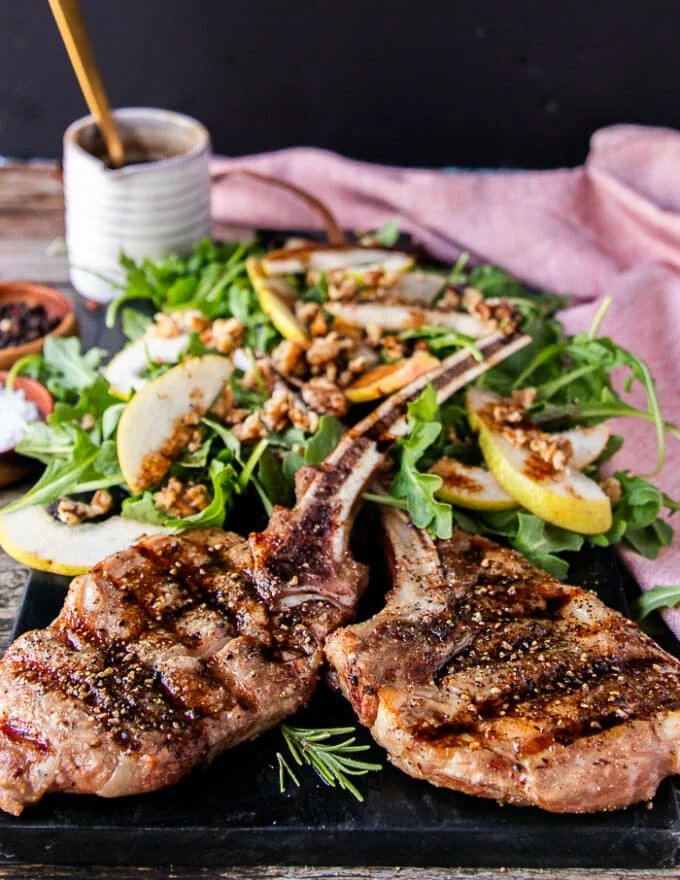 close up of two veal chops grilled and shown close on how well grilled they are. Juicy and well cooked