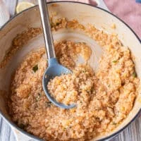 The risotto has absorbed the initial amount of stock and looks creamy and ready for more