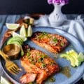 A plate with miso salmon and avocado and a fork breaking up the salmon showing how succulent it is