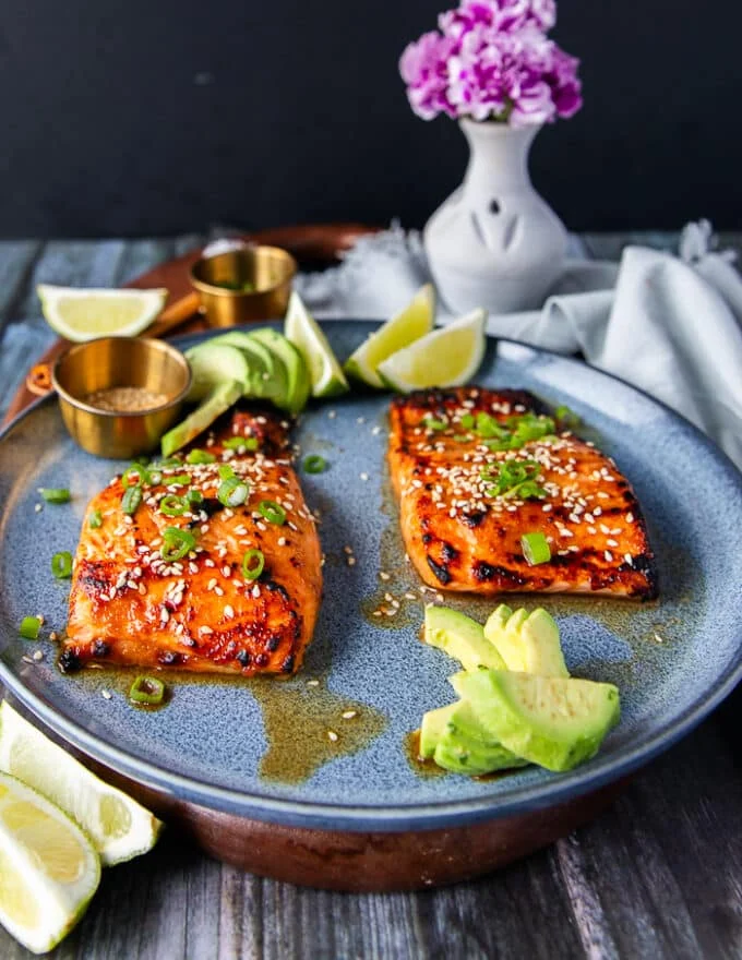 side view of two miso salmon fillets cooked and served on a plate