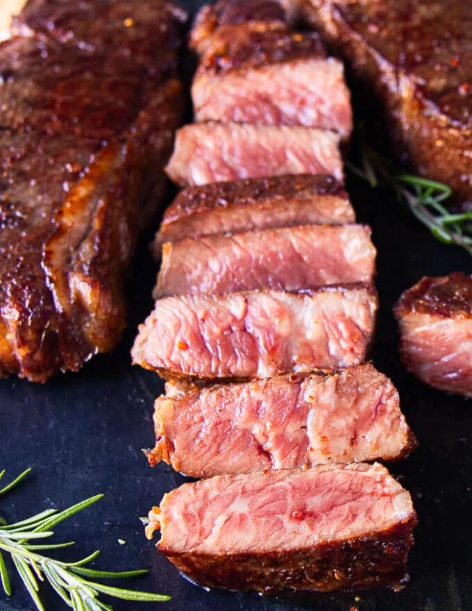 close up of a sliced reverse sear steak showing the perfect pink inside and golden sear