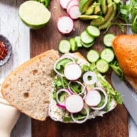 Some toppings starting to pile at the smoked salmon sandwich like arugula, onions, radishes