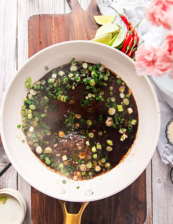The sauce ingredients all added to the skillet with the green onions to simmer.