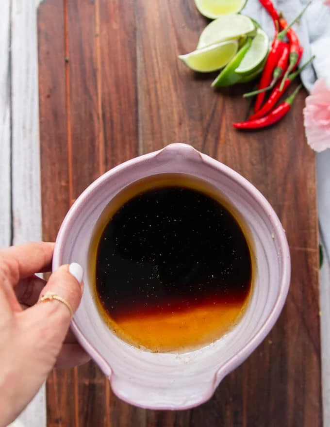 A bowl of soy sauce, rice vinegar and honey used to make the dressing for the saba noodle salad