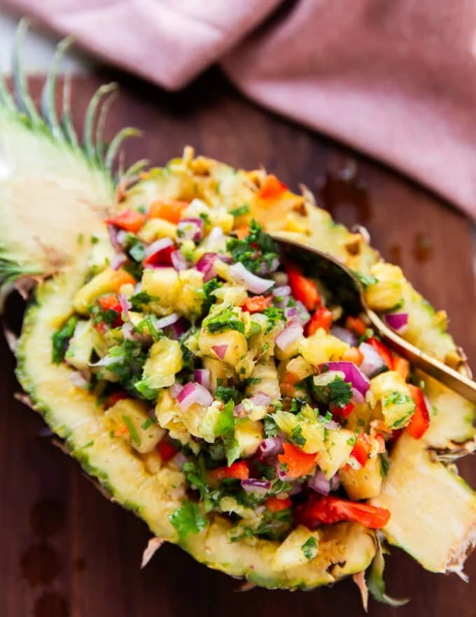 close up of a half pineapple stuffed with the pineapple salsa for a beautiful presentation