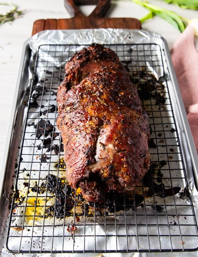 The high temperature roasting is now complete and the boneless leg of lamb has a beautiful crust and [perfect internal temperature. It is ready to rest