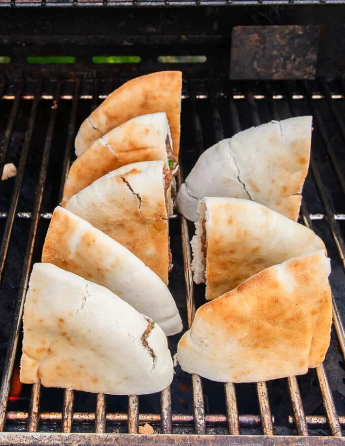 The arayes are arranged on the grill to cook