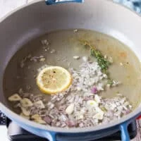 the white wine, shallots, garlic, lemon juice and slice are added to the skillet to make The beurre blanc sauce or creamy lemon sauce