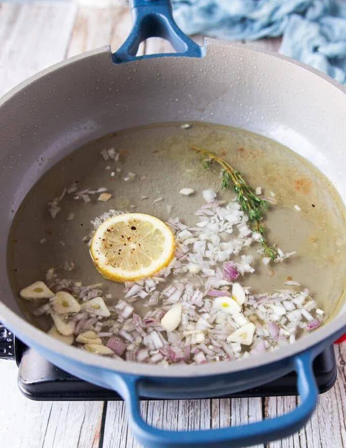 the white wine, shallots, garlic, lemon juice and slice are added to the skillet to make The beurre blanc sauce or creamy lemon sauce