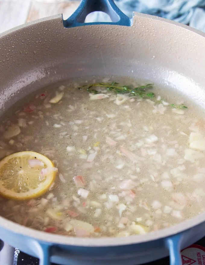 reduced white wine and shallot mixture in the skillet after simmering for 10 minutes and ready to add the cream