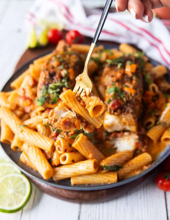 A fork eating the cajun pasta and showing the texture and sauce close up