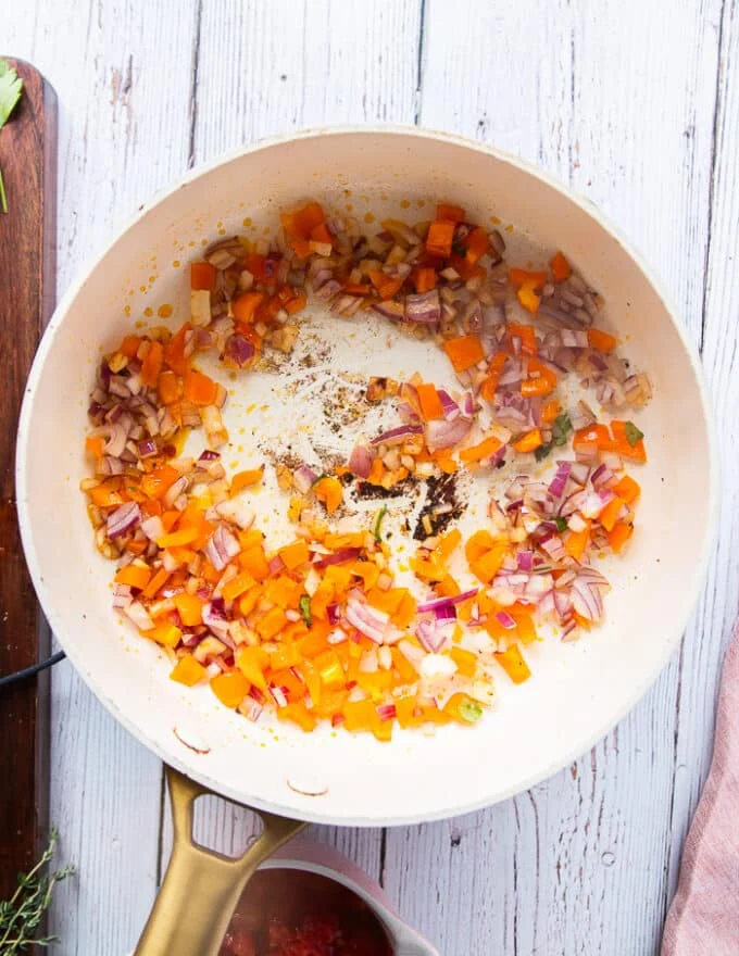 In the same skillet the cajun pasta sauce is cooking by sautéing onions and bell peppers