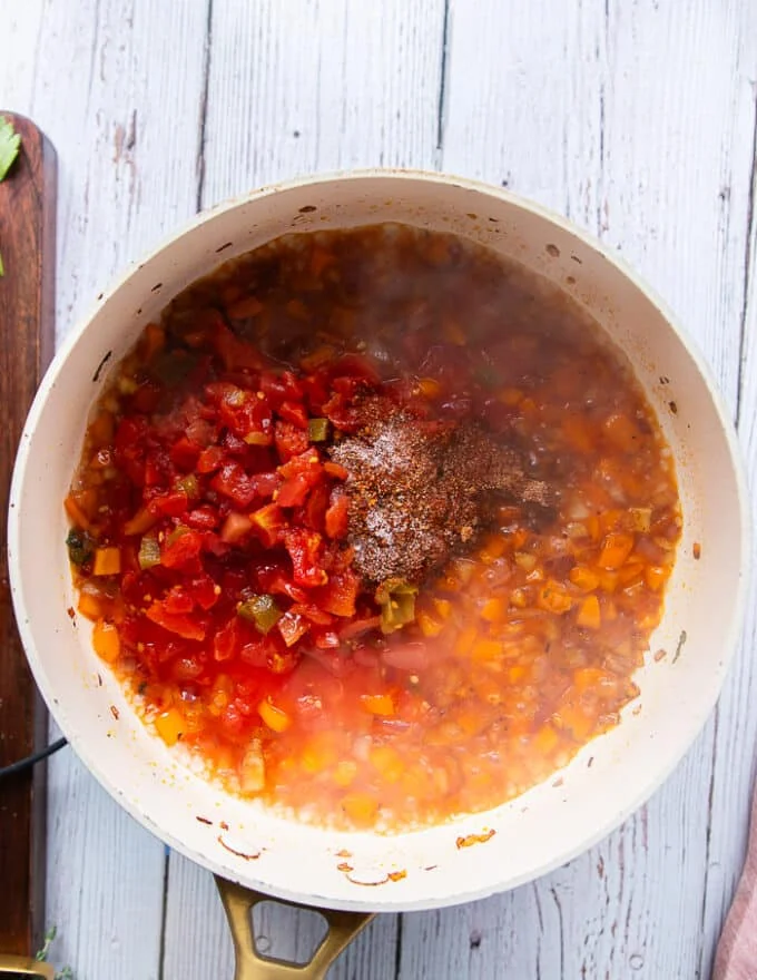 the fire roasted tomatoes along with homemade cajun seasoning is added to the skillet