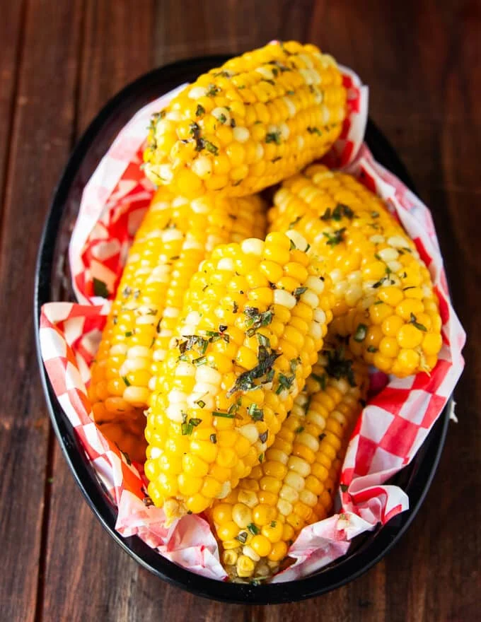 Close up of boiled corn. on the cob slathered with butter