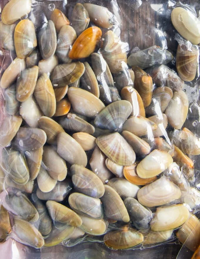 A bag of clams showing how they look when bought at the store