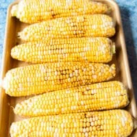 fresh seasonal corn on the cob seasoned and ready to grill