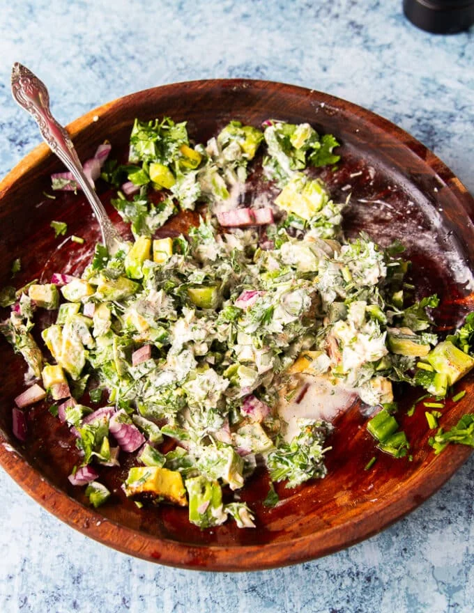 the dressing in a wooden bowl all mixed together