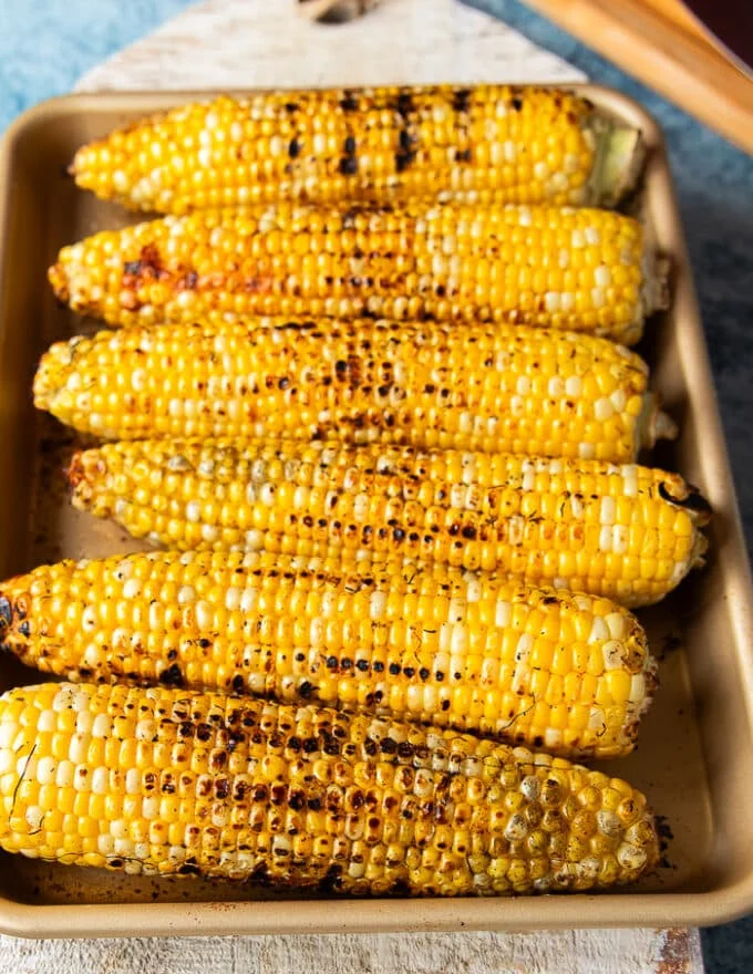 grilled corn on the cob charred and beautiful, ready to slice