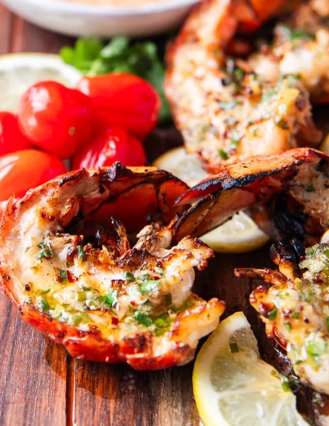 close up of grilled lobster with herb lemon butter shining
