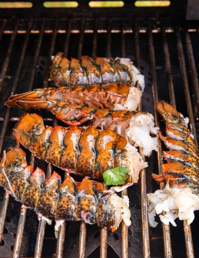 The lobster placed on the grill, meat side down