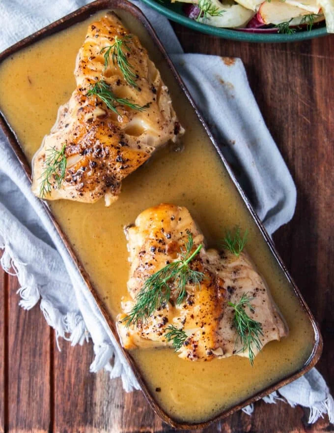 plated cod fish with lemon garlic butter sauce