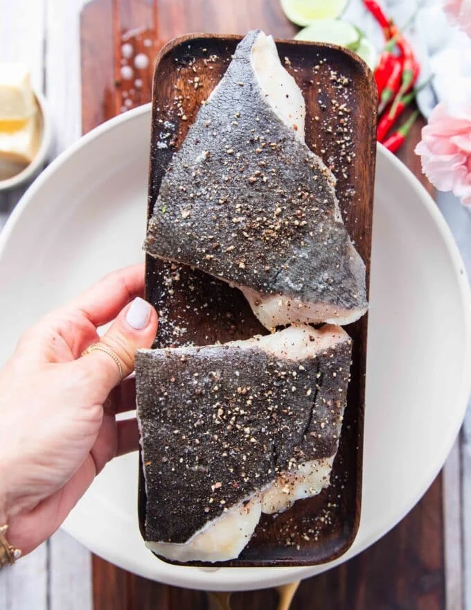 seasoning the fish to show how we can make lemon garlic butter sauce for fish