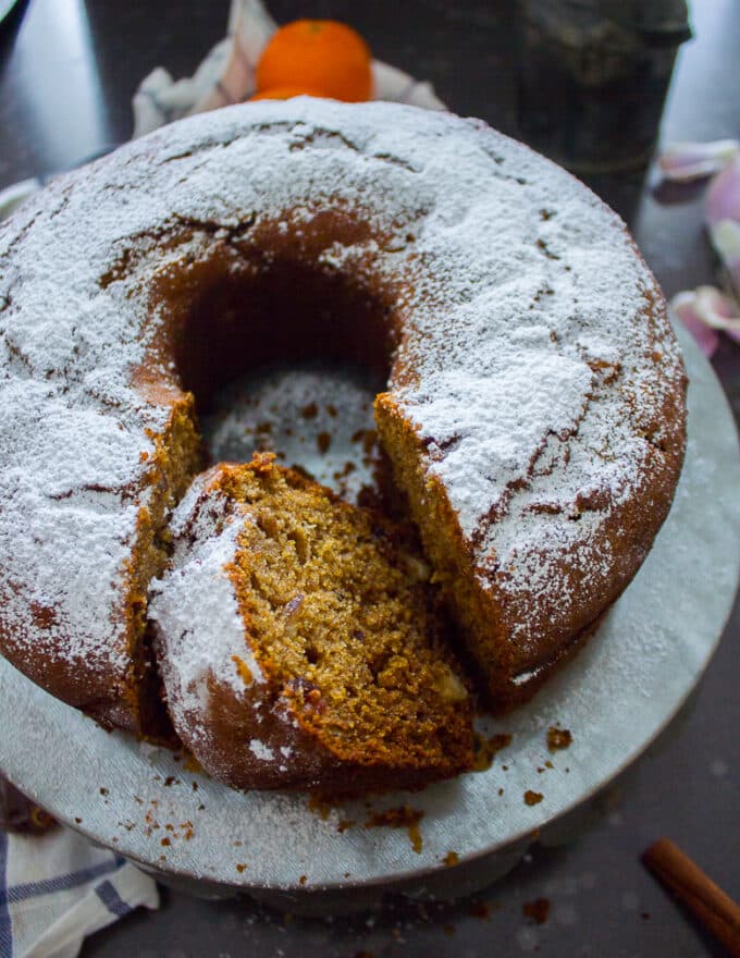 close up of a moist date cake sliced on a board