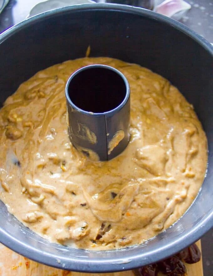 The batter poured into the greased cake pan and ready to bake