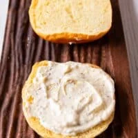 Lemon aioli is spread over the buns to assemble the salmon burgers